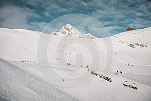 Ski resort in winter Alps. Skiers ride down the slope. Tux, Hintertux, Austria