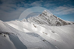 Ski resort in winter Alps. Skiers ride down the slope. Tux, Hintertux, Austria