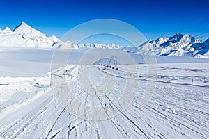 Ski slope in the mountains. Sunny winter landscape