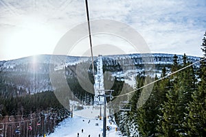 Ski slope, people skiing down the hill, mountains view