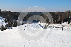 Ski slope, people skiing down the hill, mountains view. Cesis. Latvia