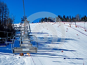 Ski slope with ski lifts and slalom gates