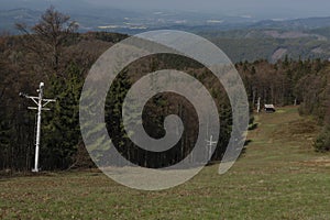 Ski slope with ski tow near Radhost hill in spring sunny day