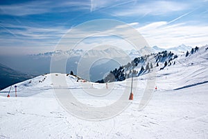 Ski slope and snowy mountains in the Austrian Alps