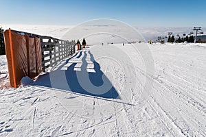 Ski slope, Snowy pathway with wooden fence in wintertime