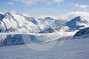 Ski slope in winter mountains