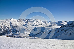 Ski slope in winter mountains