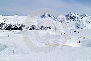Ski slopes in high Alps near chalet winter resort