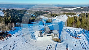 Ski slopes with skiers, snowboarders and chairlift in Poland