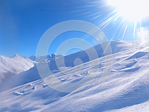 Ski snow slope and blue sky with sun