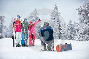 Ski, snow sun and fun - family on ski holiday taking picture