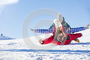 Ski, snow sun and fun - happy family on ski holiday