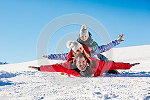 Ski, snow sun and fun - happy family on ski holiday