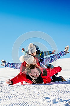 Ski, snow sun and fun - happy family on ski holiday