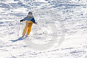 Ski, snow, sun and fun with kids on a snow track,child on ski