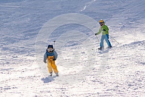 Ski, snow, sun and fun with kids on a snow track,child on ski