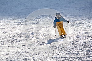 Ski, snow, sun and fun with kids on a snow track,child on ski