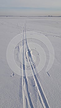 Ski, snow and track crossing a frozen lake. Winter sport - cross-country skiing