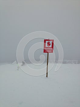 Ski station, piste closed, Are, Sweden. Stop sign in snow, bad weather