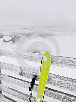 Ski stick in snow mountains on background