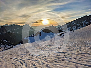 ski tour at sunrise, Ski mountaineering ski touring on a mountain peak in the swiss alps. Clariden. Glarus uri. Winter