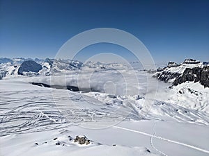 Ski tour in the Swiss mountains. View of the snowy mountains above the clouds. Fantastic views and a powder run. Glarus