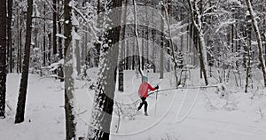 Ski touring in deep fresh snow - young couple skiing in snowy winter forest