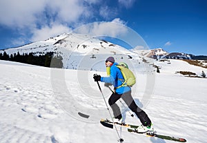 Ski touring man ascending during ski touring in the spectacularly white mountains