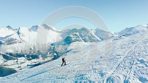 Ski touring man walk up mountain fjord in Norway