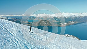 Ski touring man walk up mountain fjord in Norway