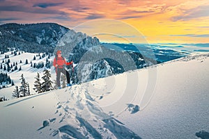 Ski touring on the snowy slopes at sunset, Carpathians, Romania