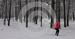 Ski touring - young couple skiing down the hill in snowy winter forest