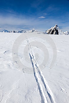 Ski track on fresh snow. Winter sport background with the famous