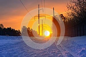 Ski track on snow surface against the rising sun