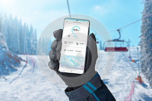 Ski tracking app on smartphone in man hand on ski lift