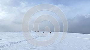 Ski trip across the expanses of Russia. Beautiful winter landscape. A group of skiers is skiing on a snow-white field