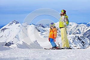 Ski vacation in mountains, woman and child happy
