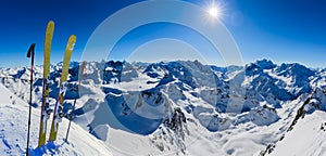 Ski in winter season, mountains and ski touring backcountry equipments on the top of snowy mountains in sunny day, Verbier