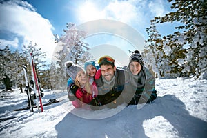 Ski, winter, snow, sun and fun - family enjoying in winter vacations