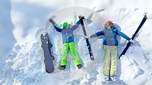 Ski woman and young boy with snowboard view from above