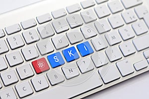 SKI writing on white keyboard with a snowflake sketch