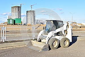 Skid-steer loader for loading and unloading works on city streets. ÃÂ¡ompact construction equipment for work in limited conditions