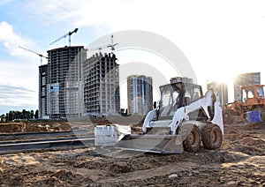 Skid-steer loader for loading and unloading works on city streets. ÃÂ¡ompact construction equipment for work in limited conditions