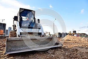 Skid-steer loader for loading and unloading works on city streets. ÃÂ¡ompact construction equipment for work in limited conditions