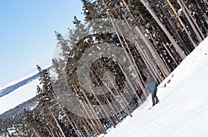 Skier carving down from steep slope