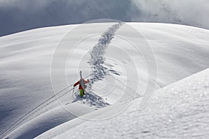 Skier climbing a snowy mountain