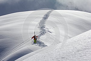 Skier climbing a snowy mountain