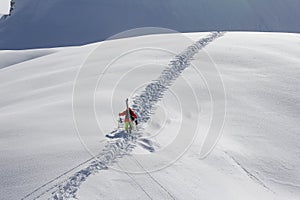 Skier climbing a snowy mountain