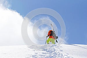 Skier climbing a snowy mountain