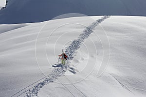 Skier climbing a snowy mountain